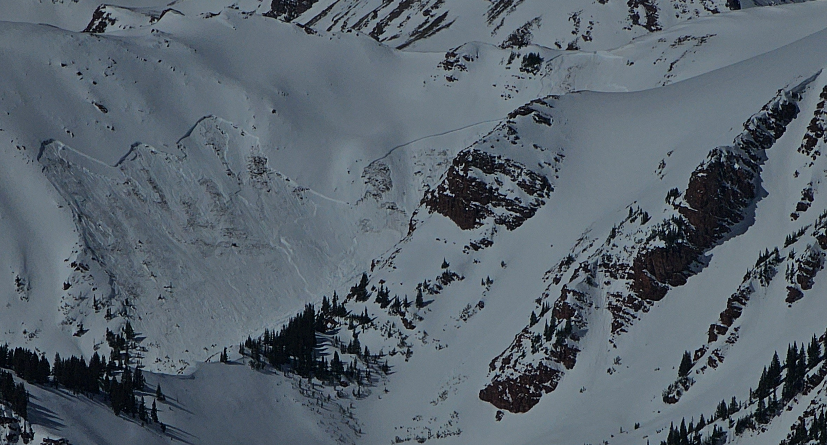 Looking down at a very large avalanche that broke to the ground in places.