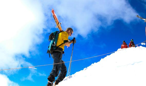 man skinning up a mountain