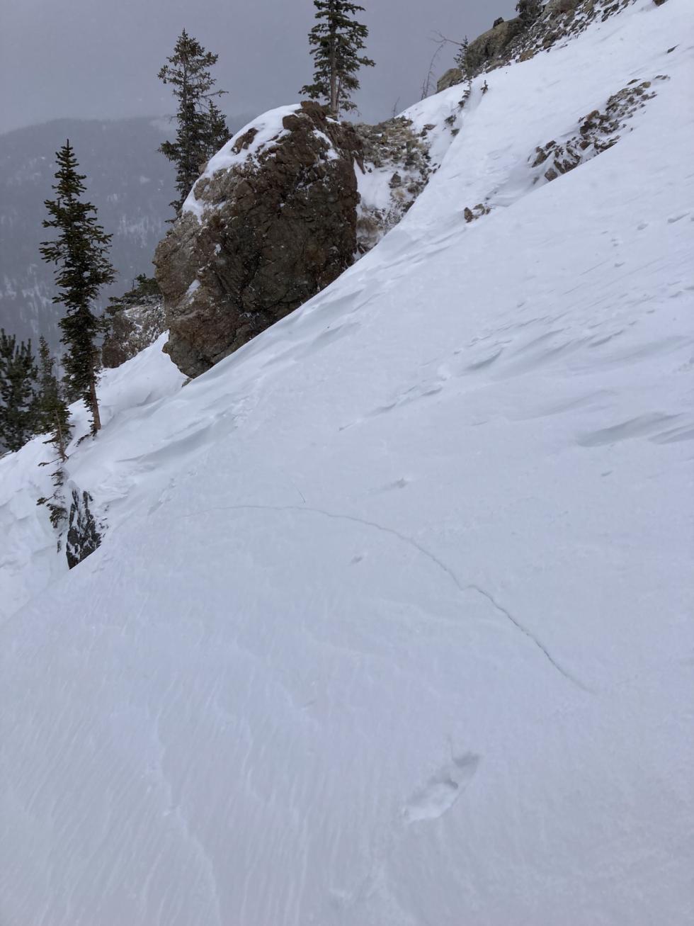 Stormy scene. looking down at stiff snow with cracks in it. 