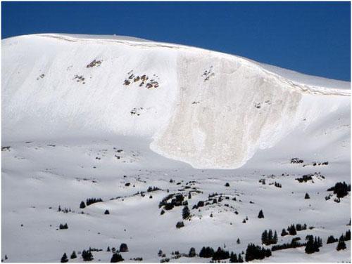 A Wet Slab avalanche. In this avalanche, the meltwater pooled above a dusty layer of snow. Note all the smaller wet loose avalanches to either side.